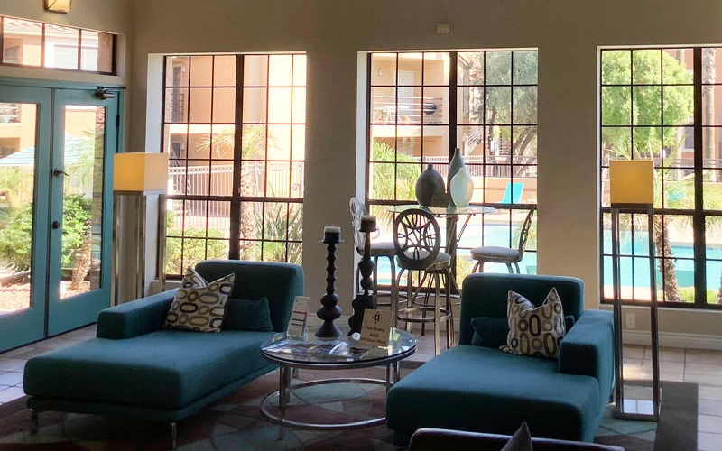 large windows brighten resident lounge and provide poolside views
