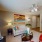 carpeted living room with ceiling fan and light fixture